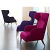 Three lounge chairs - one black, one purple, one pink