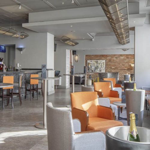 Hotel bar area with grey and orange chairs
