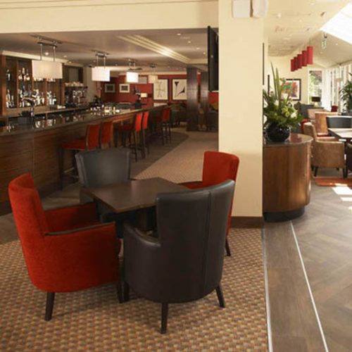 Hotel bar and dining area with red and brown armchairs