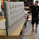 The manufacture of a grey buttoned headboard