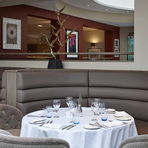 Hotel dining area with grey banquette seating