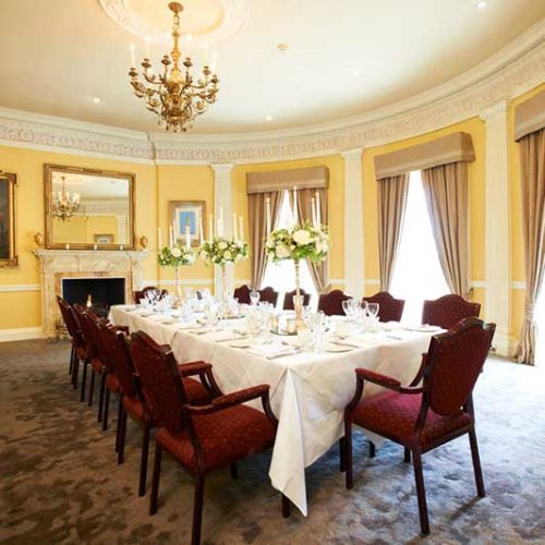 Red banquet chairs around a large table